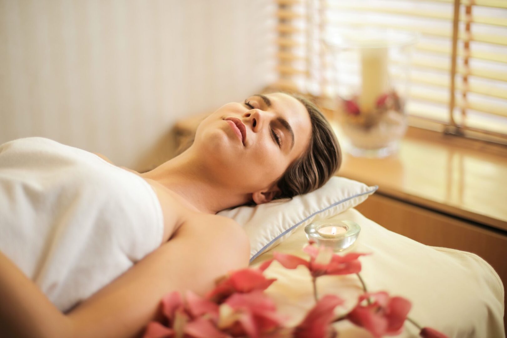 woman-in-wrapped-in-white-towel-lying-on-bed-with-eyes-3757942